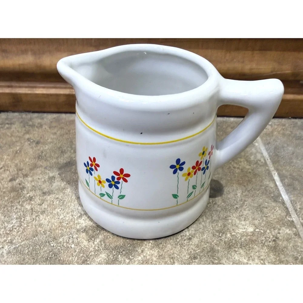 Vintage ceramic 3/4 cup measuring pitcher with charming floral design.